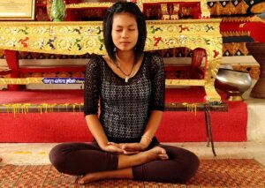 Woman in lotus position meditating.