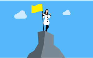 Cartoon of woman with flag on top of mountain